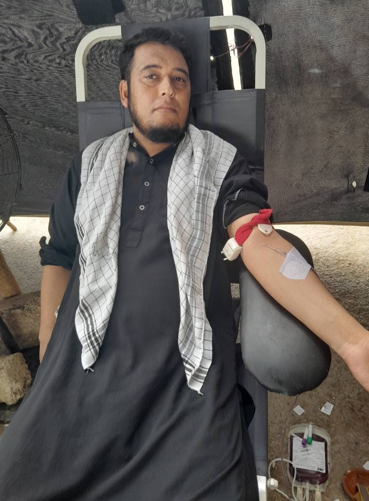 A donor giving blood at a BMT camp